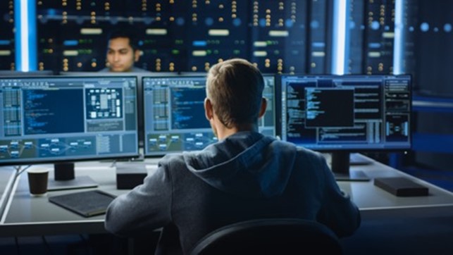 man on desktop computer in security centre