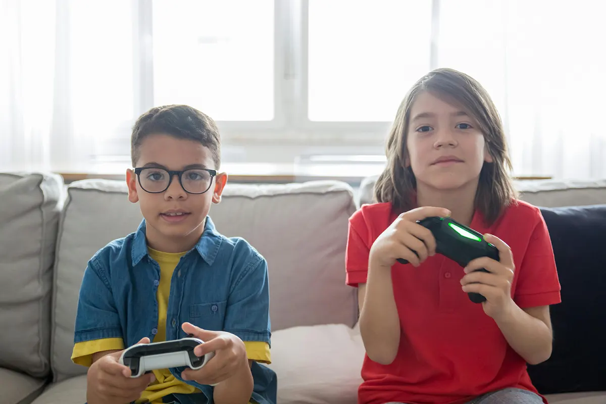 Brother and sister playing video console games